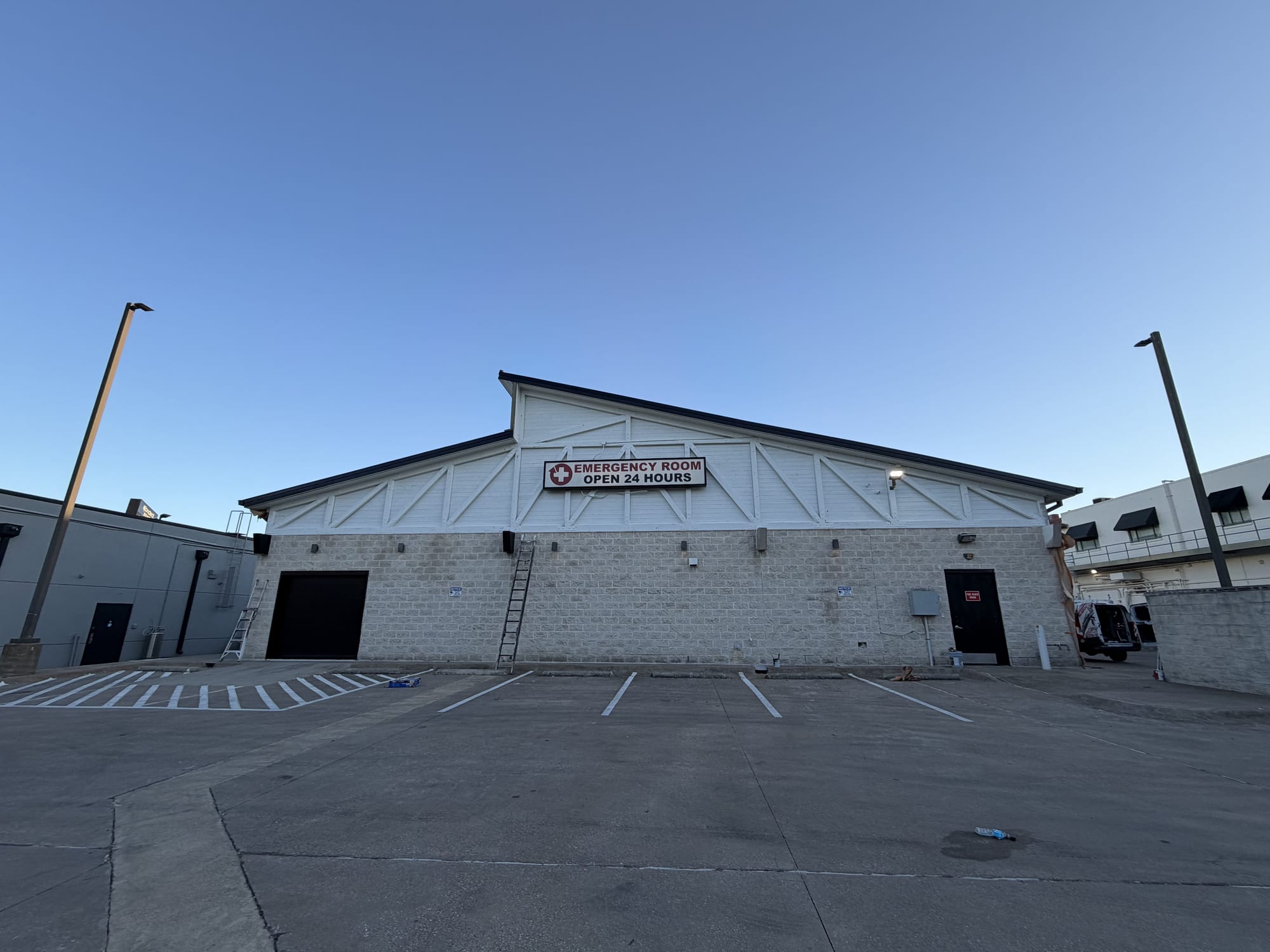 Commercial emergency care building with weathered trusses before repainting, Spartan Painting