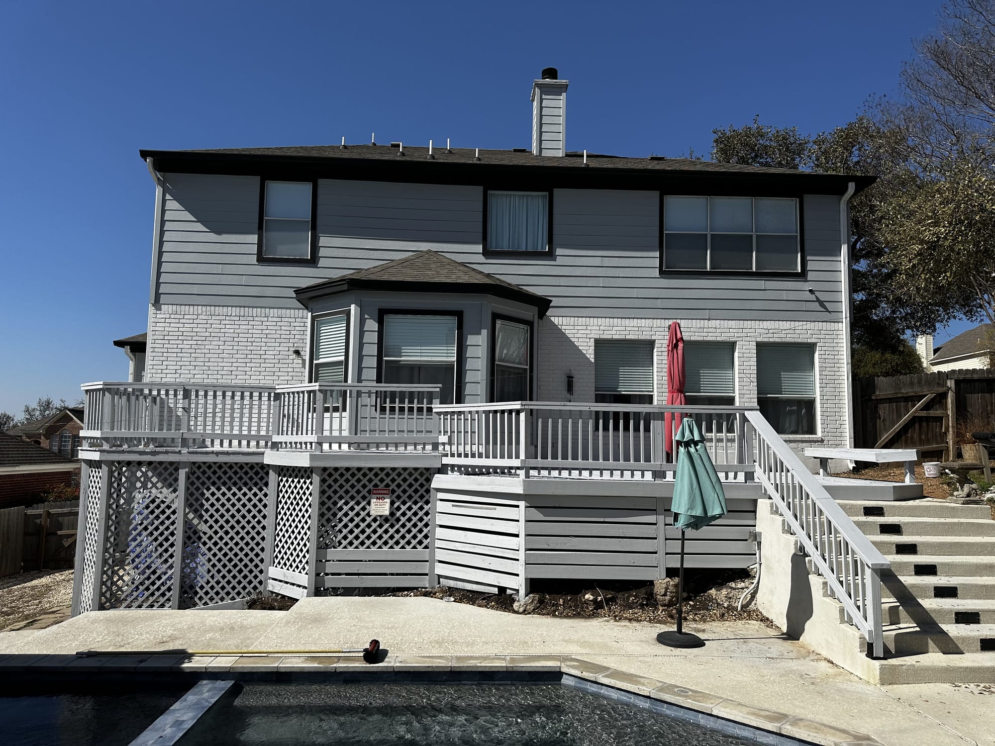 Same rear deck, rails, and stairs refinished in fresh gray, Spartan Painting