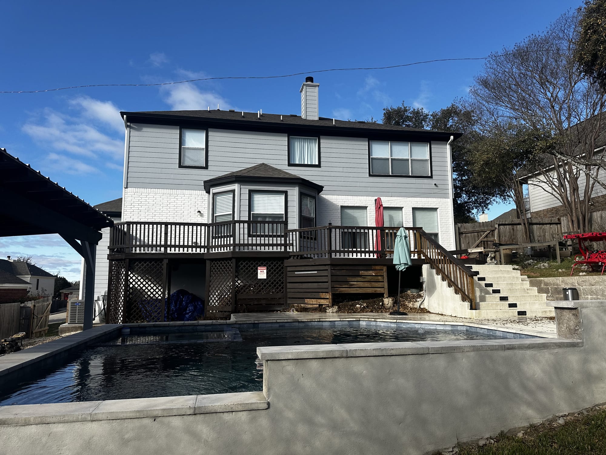 Weathered two-story rear deck and stairs before refinishing, Spartan Painting
