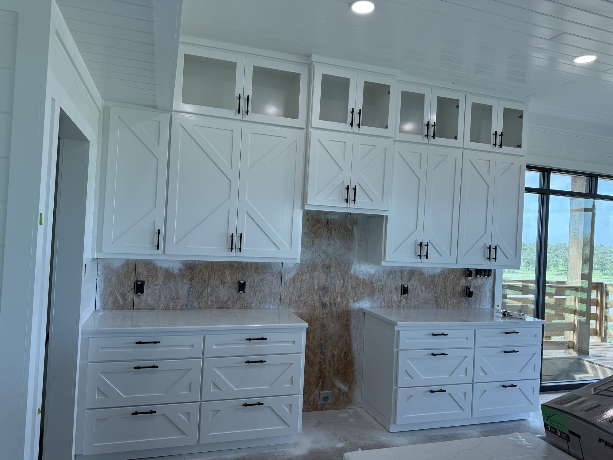 Same kitchen cabinets sprayed a smooth white finish