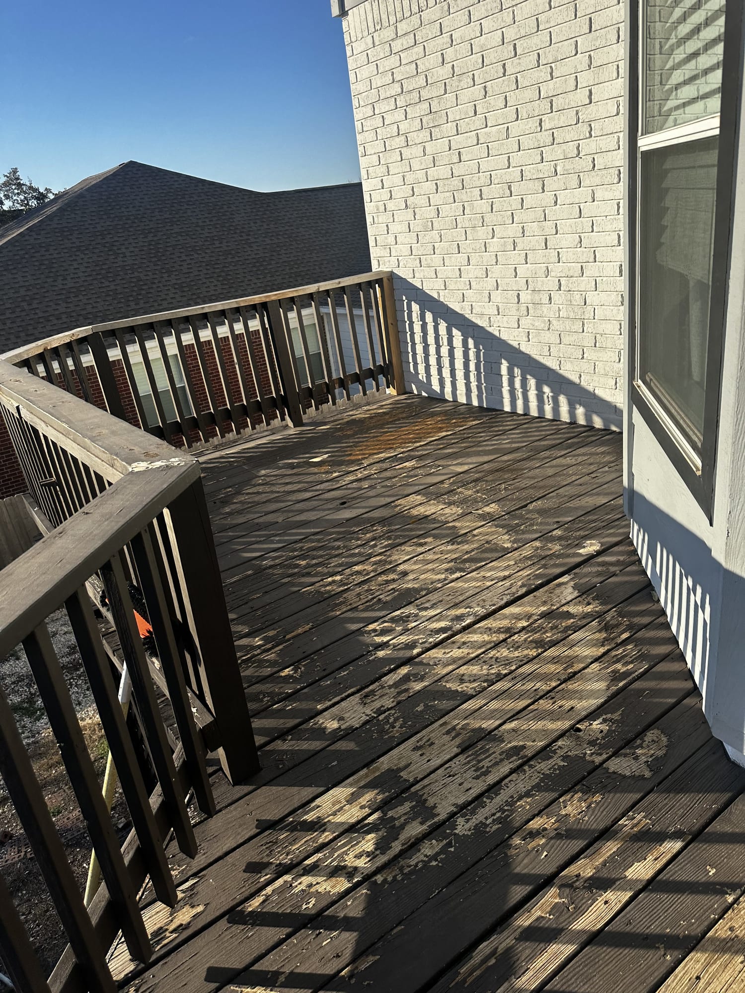 Weathered gray deck boards before cleaning and restaining